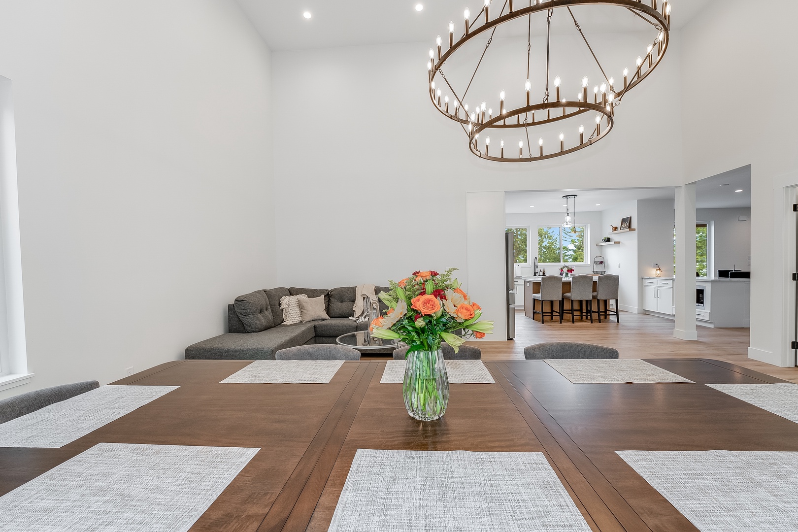 Picture yourself gathered around this beautiful dining table, the warm wood and stunning chandelier setting the scene for memorable meals with loved ones.
