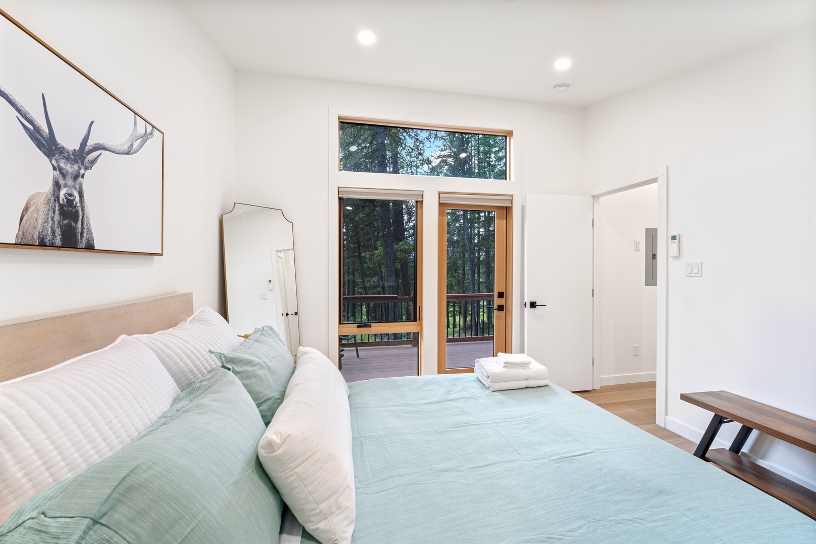 Your serene bedroom opens to a private forest balcony where morning coffee tastes even better surrounded by towering trees.