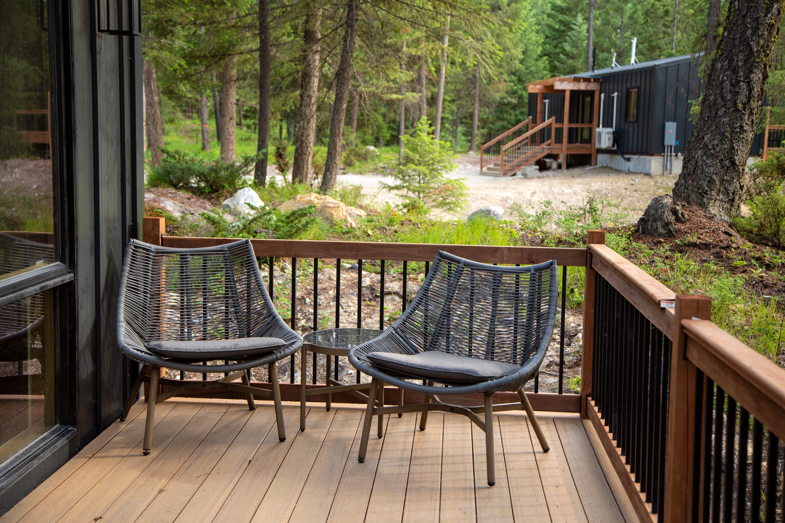 Your private deck offers forest serenity with comfortable seating where you can unwind among towering trees and natural wilderness.