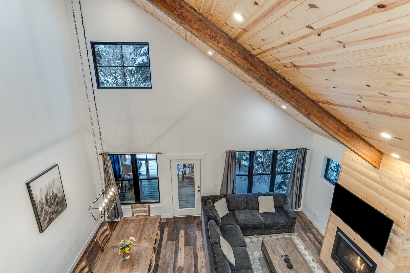 Your cozy loft retreat with soaring wood ceilings, where you'll unwind by the fireplace after snowy mountain adventures.