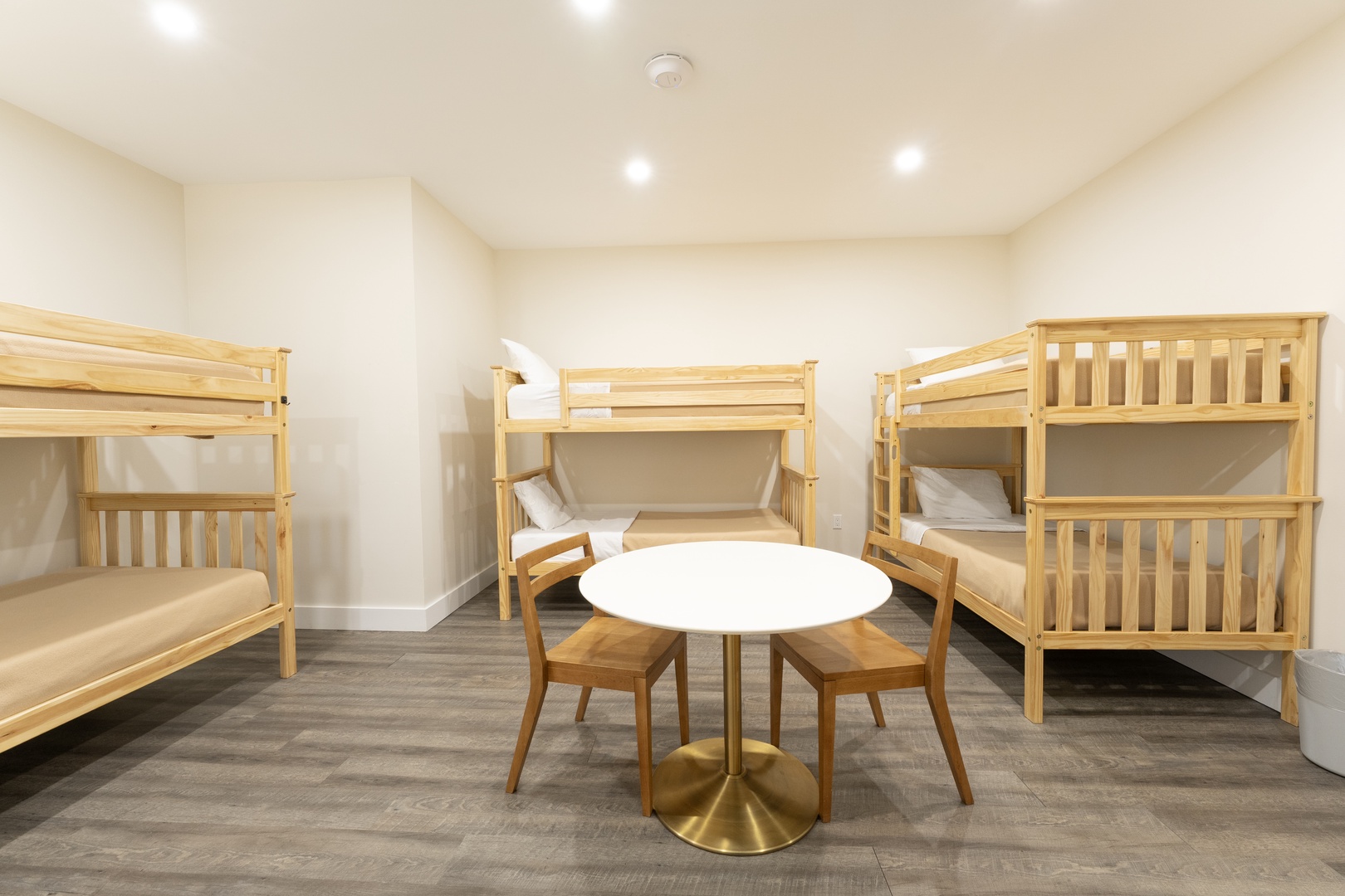Gather with friends and family in your cozy bunk room, where comfortable sleeping spaces and a central table invite you to share stories and laughter together.
