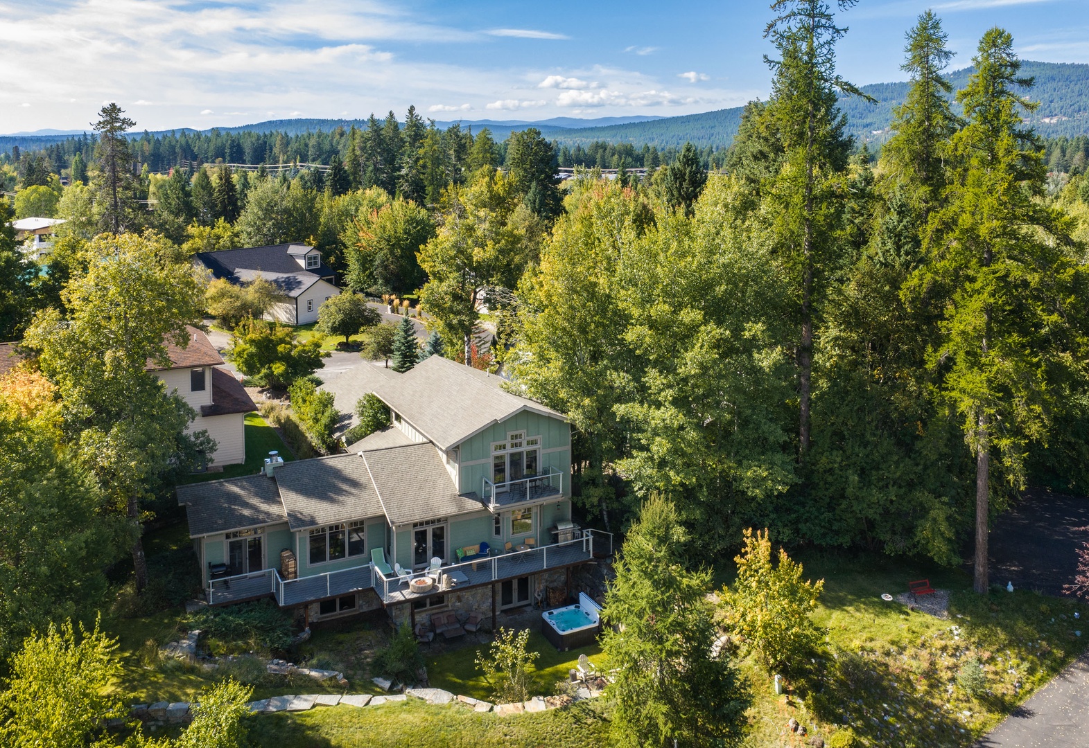 Nestled in a peaceful forest-lined neighborhood, this spacious two-story home offers mountain-framed horizons and multiple outdoor decks, perfect for your scenic getaway.
