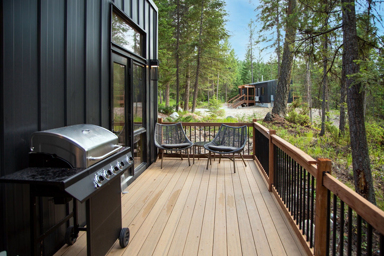 Your private deck offers peaceful forest views with a BBQ grill for memorable outdoor meals among the trees.
