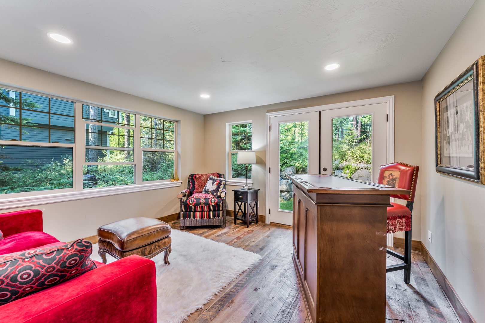 Curl up in your cozy sitting area, where natural light pours through large windows and French doors open to lush garden views—perfect for morning coffee or quiet moments.