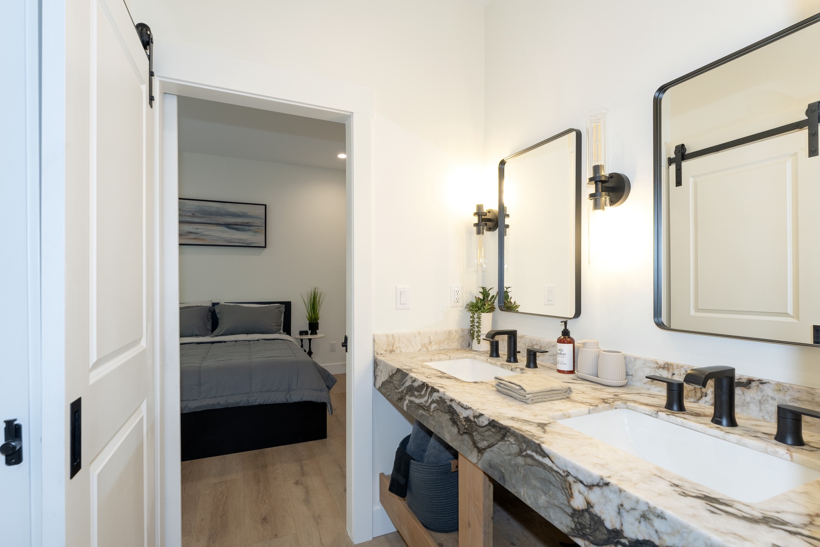 Freshen up in your elegant double-vanity bathroom with stunning marble countertops, modern fixtures, and soft lighting—just steps from your restful bedroom.