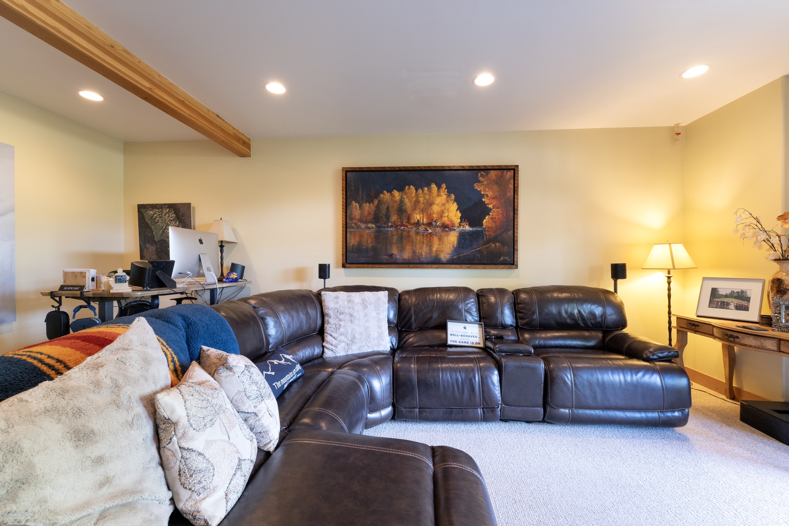 Sink into the plush leather sectional and let the warmth of the lamps and wood beam details wrap around you—this inviting space is where your days begin and end in comfort.