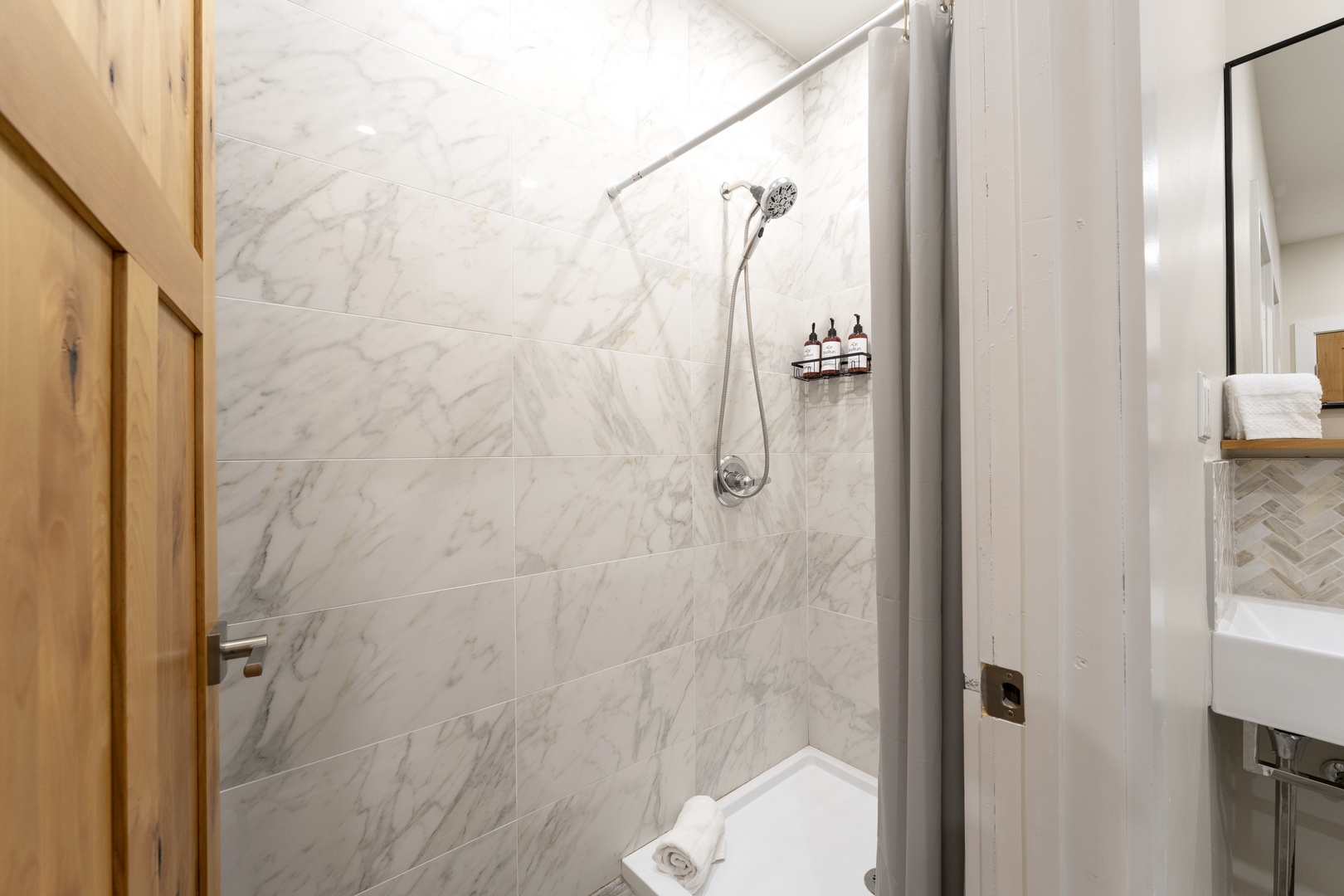 Step into a sleek, modern bathroom with beautiful marble finishes and a rainfall shower—your perfect retreat for unwinding after a day of exploring.