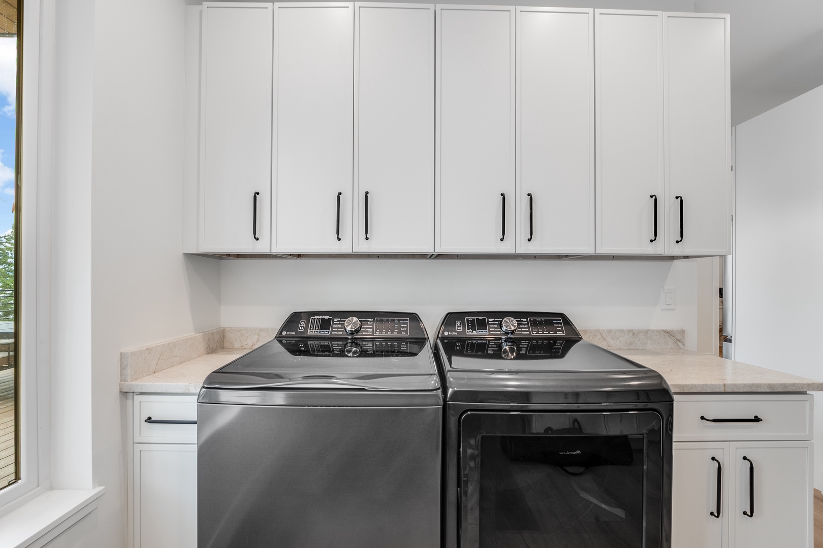 Your dedicated laundry space features modern machines and ample cabinetry for easy organization during your stay.