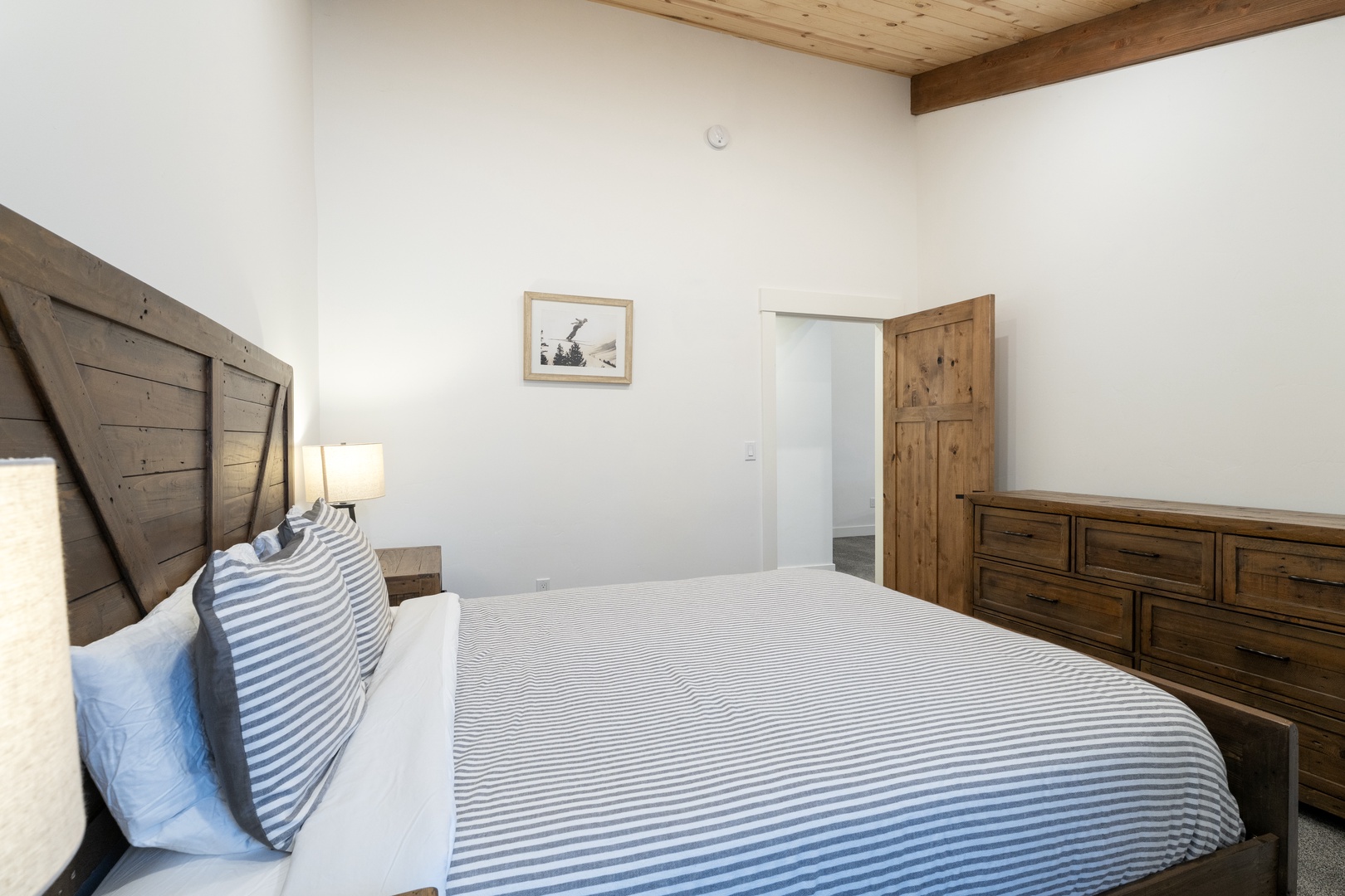 Rest peacefully in your charming bedroom with rustic wood beams, crisp linens, and thoughtful touches that make you feel right at home.