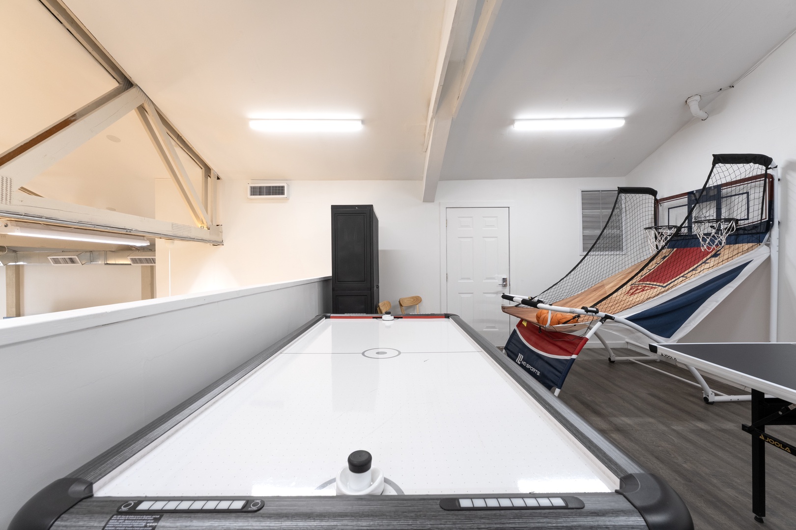 Step into your own private game room with a sleek air hockey table and arcade basketball, perfect for friendly competitions and unforgettable fun-filled evenings.