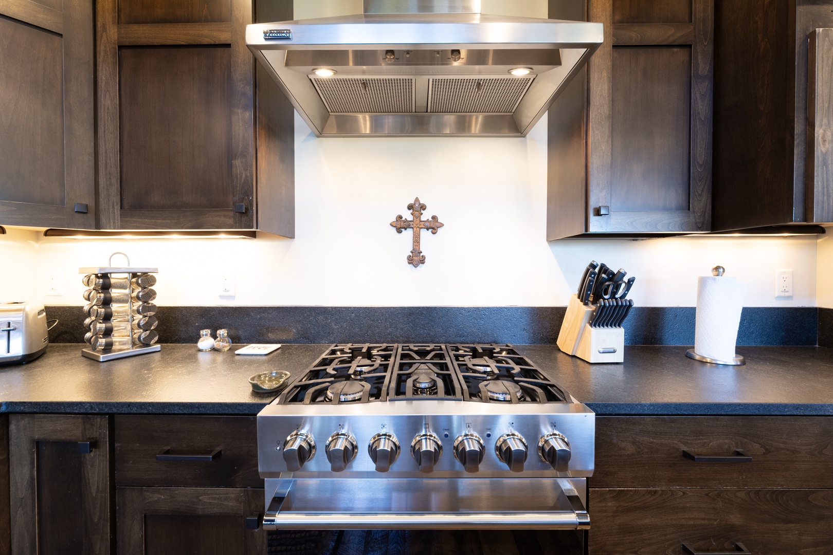 A sleek modern kitchen awaits your culinary adventures, featuring a professional gas range and ample counter space for preparing memorable meals during your stay.