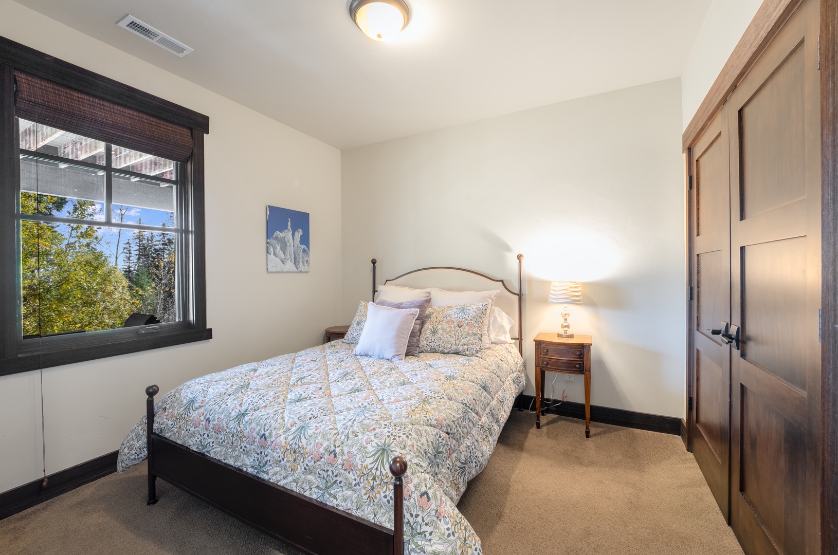 Curl up in your cozy bedroom, where a plush bed and warm lighting welcome you after a day of exploring. Sunlight streams through the window, adding a gentle touch of the outdoors.