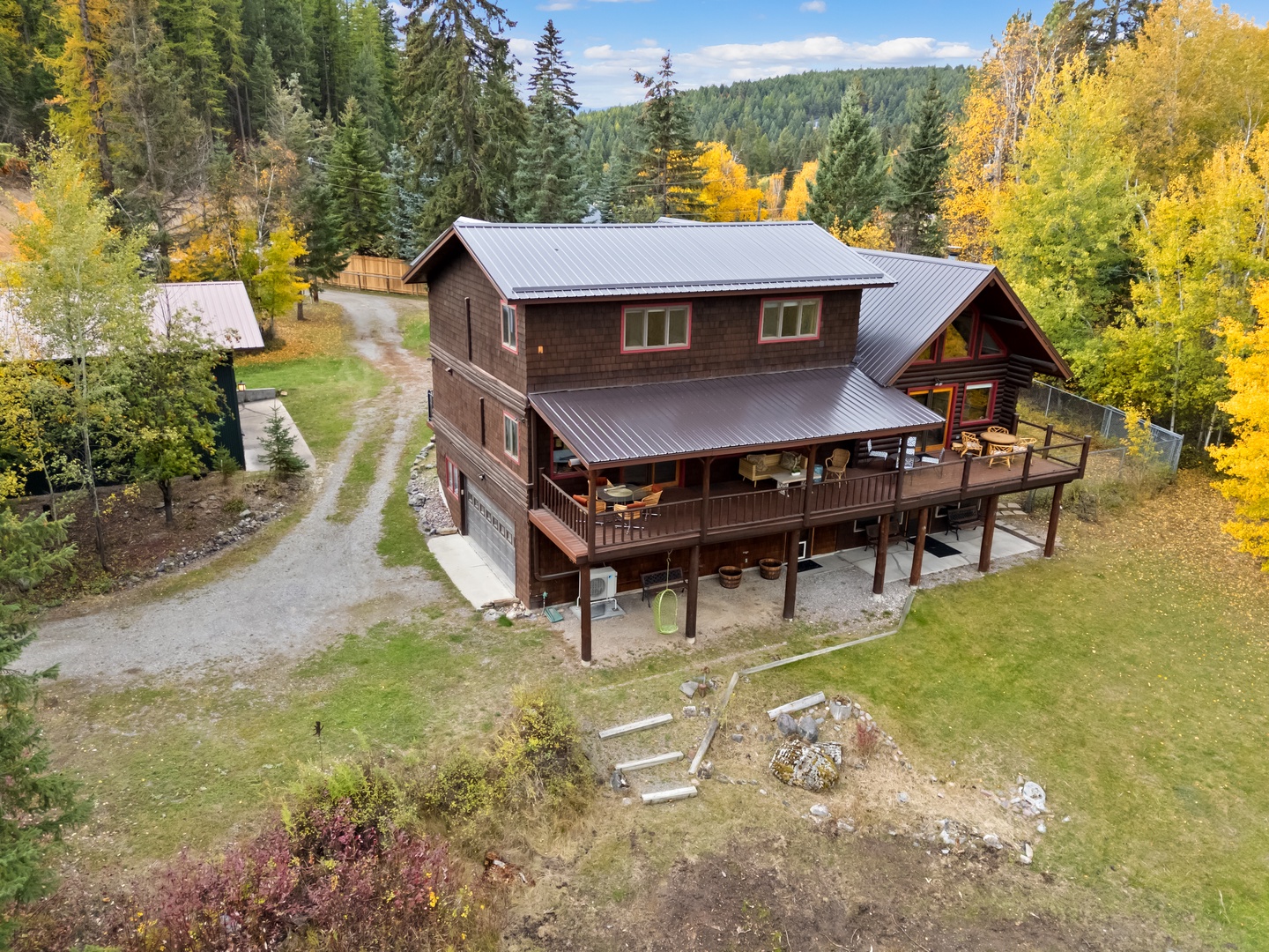 Rustic mountain lodge nestled among vibrant autumn forests, offering peaceful seclusion with sweeping natural views.