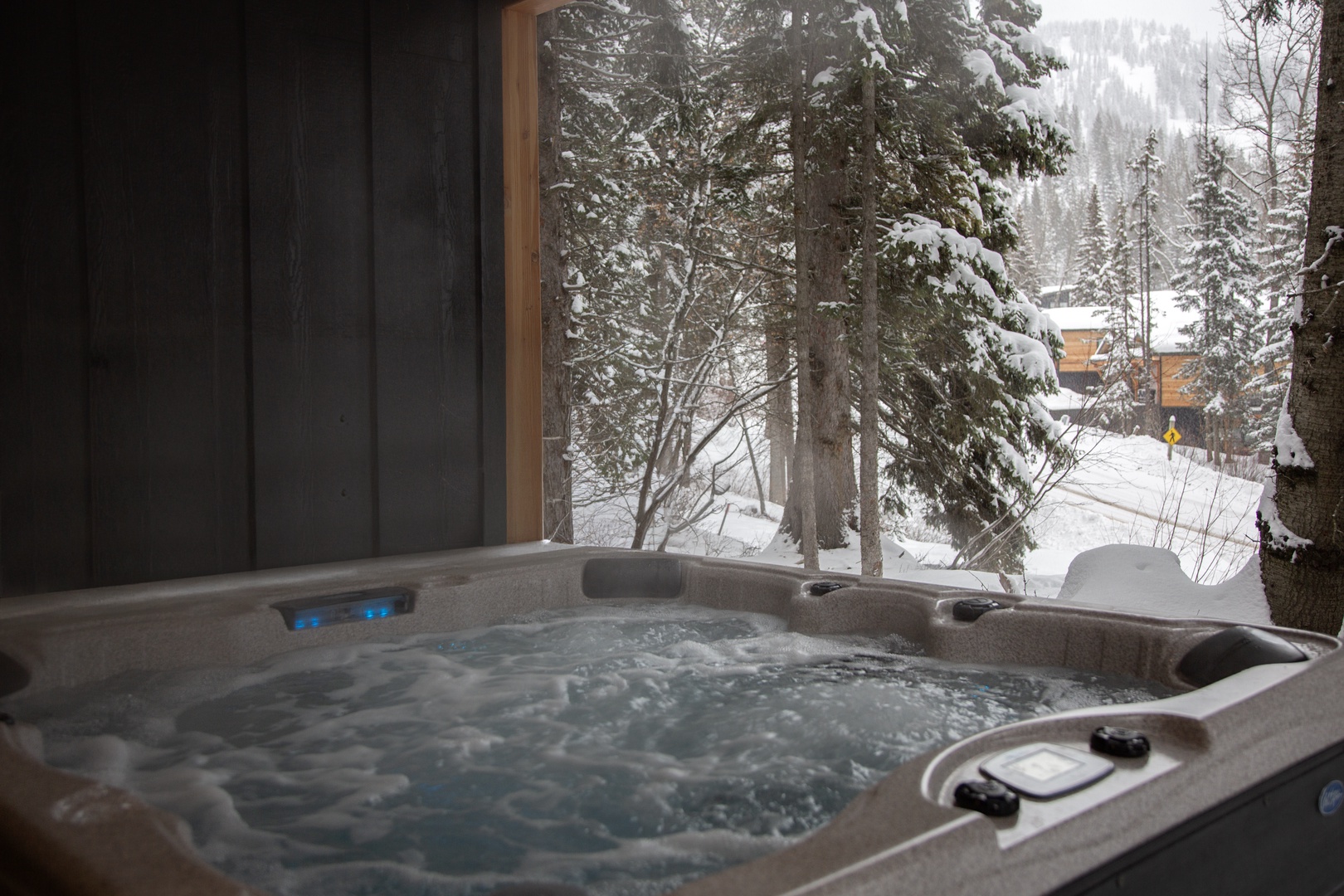 Soak in your private hot tub while snow-laden pines create a magical winter wonderland just outside your window.