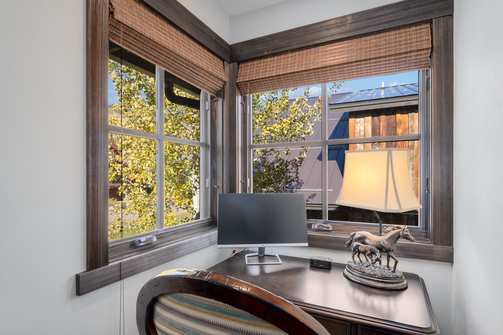 Your private corner workspace offers peaceful neighborhood views through charming windows, where natural light and tree-lined surroundings inspire focus and creativity throughout your stay.