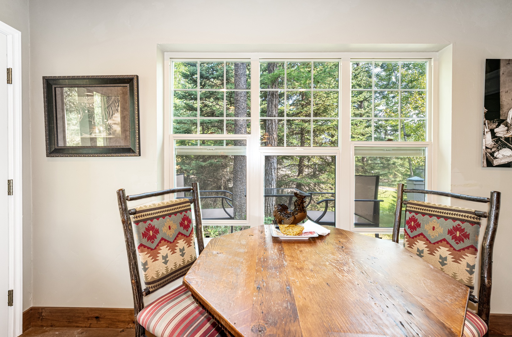 Gather around this rustic dining table and enjoy your morning coffee with stunning forest views right outside your window. The warm wood tones and natural light create the perfect spot for memorable meals.
