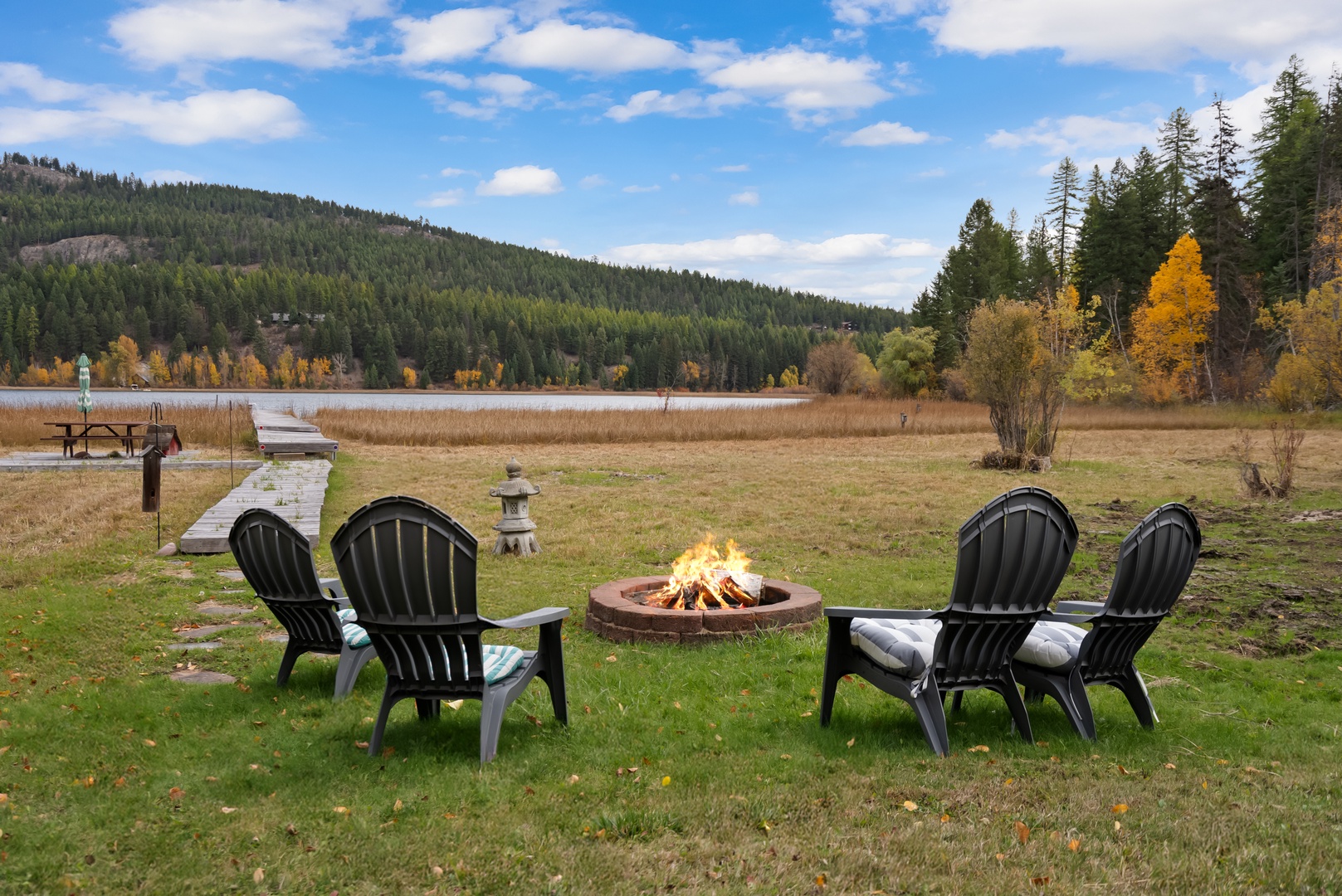 Gather around your private fire pit for cozy evenings, surrounded by autumn colors and peaceful lake views.