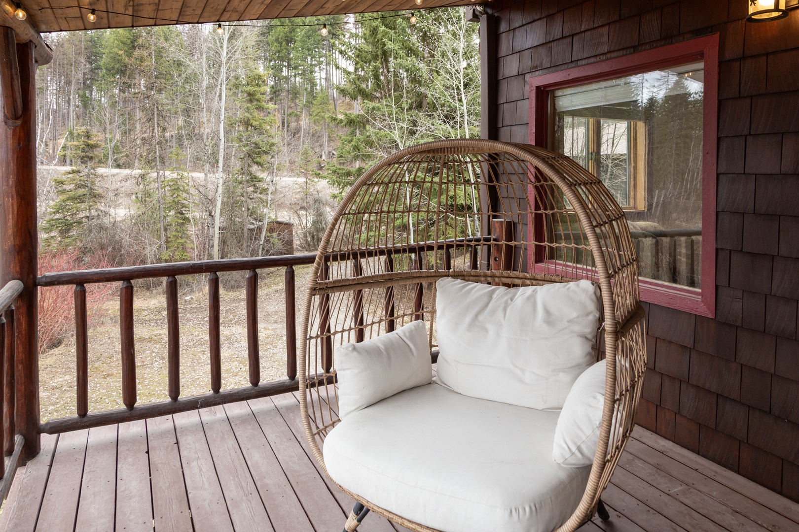 Sink into this cozy wicker egg chair on your private deck, where forest views create the perfect backdrop for morning coffee or evening relaxation.