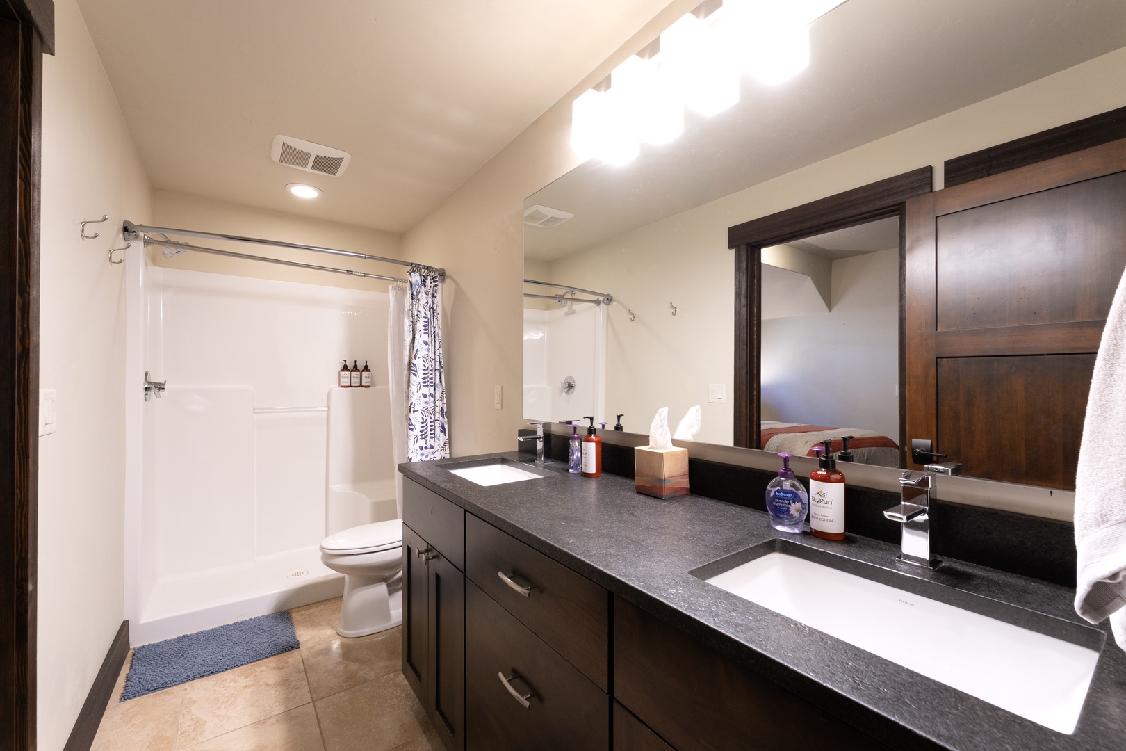 Your private bathroom features a sleek vanity, a crisp white shower-tub combo, and thoughtful touches like quality toiletries to make you feel right at home.