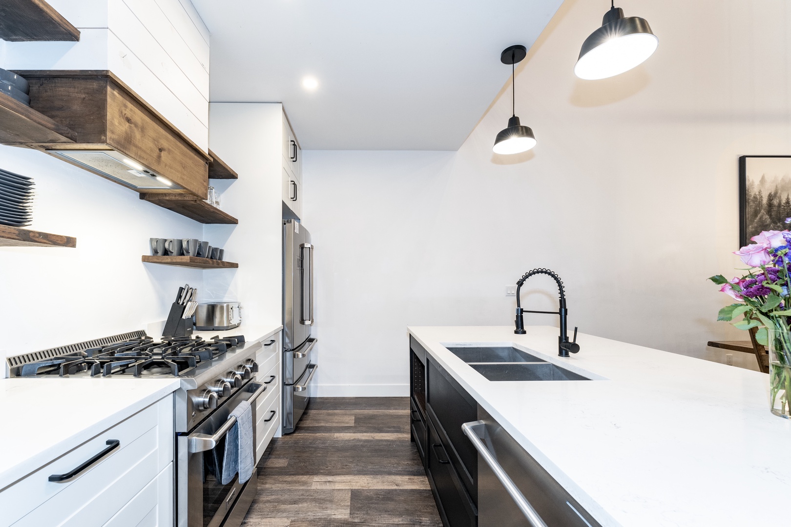 Your culinary dreams come to life in this sleek modern kitchen with premium appliances and stylish pendant lighting.