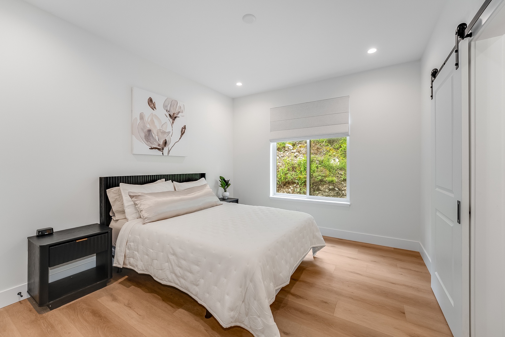 Slip into crisp white linens and wake to garden views framing your window. The warm wood floors and serene decor create your peaceful retreat after a day of exploration.
