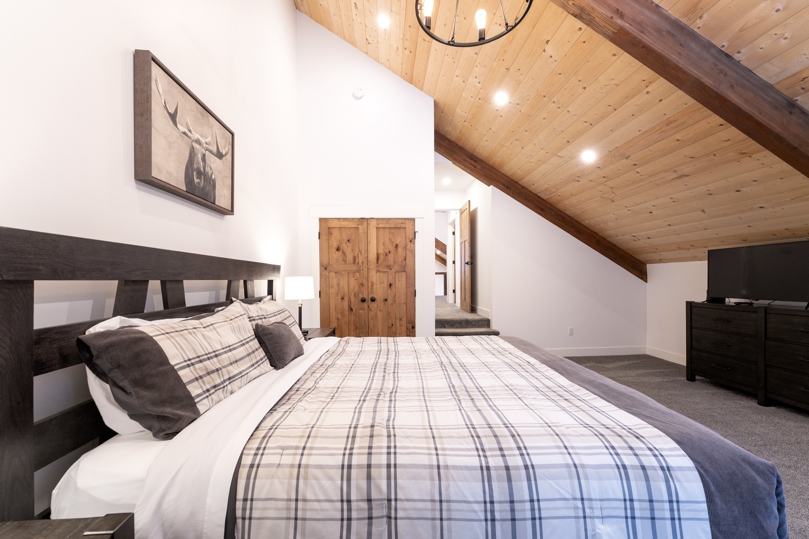 Drift off under warm wood beams in your cozy alpine retreat, where rustic charm meets modern comfort.