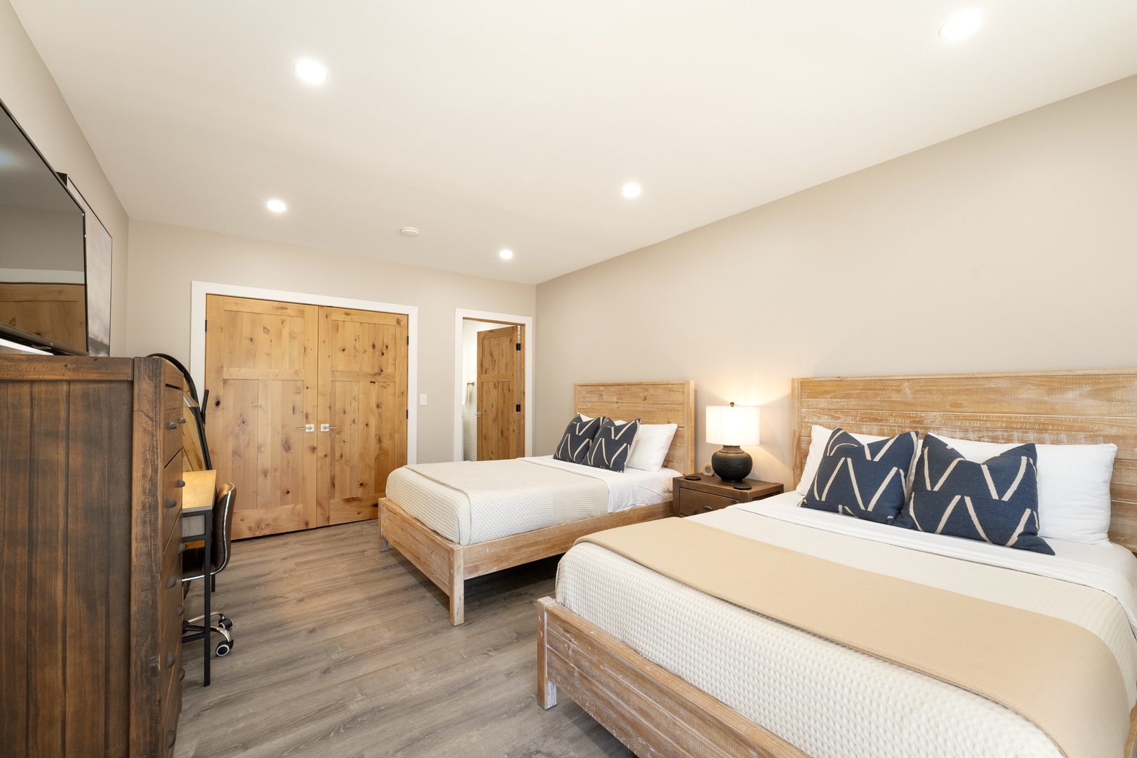 Unwind in your private retreat with two plush beds, crisp linens, and warm wood tones that create the perfect space for restful nights and peaceful mornings.