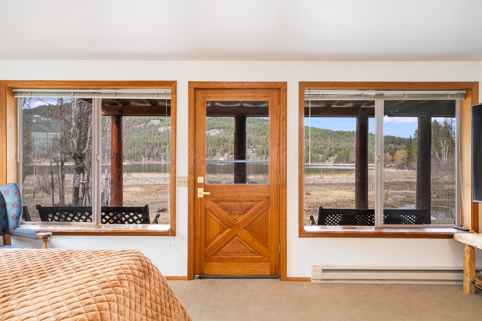 Wake up to stunning mountain vistas through your private windows, where rustic charm meets natural beauty in this serene bedroom retreat.