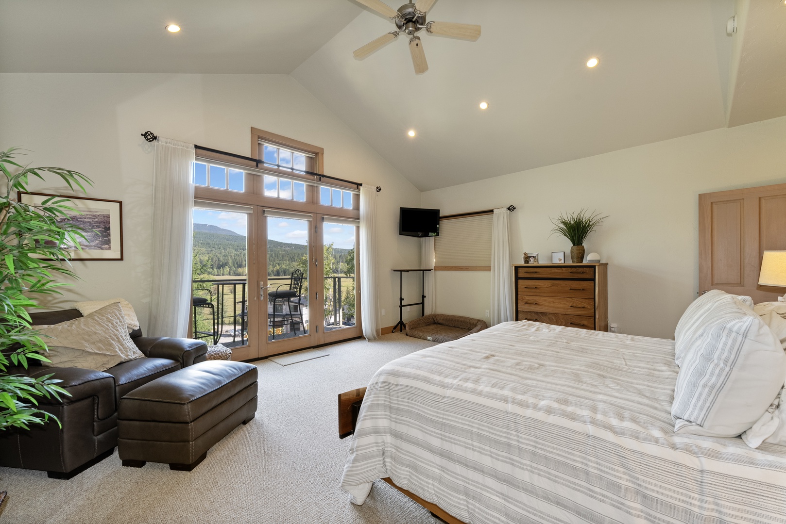 Wake up to stunning mountain views through your private balcony doors. The vaulted ceiling and peaceful setting create a spacious, serene retreat perfect for unwinding after your adventures.