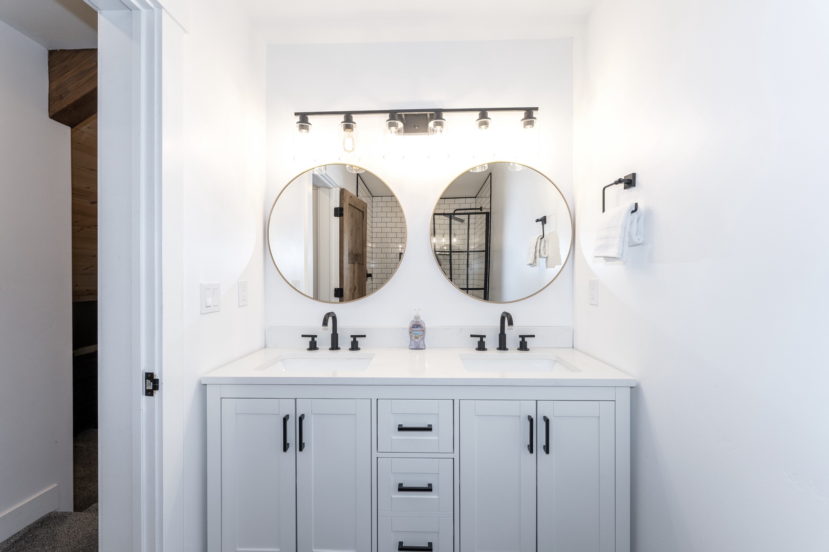Freshen up at your stylish double vanity with elegant round mirrors and abundant counter space for your morning routine.
