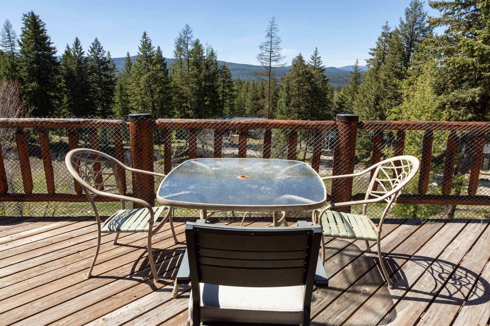 Picture yourself sipping morning coffee at your private deck table, breathing in crisp mountain air as towering evergreens frame peaceful forest views stretching to distant peaks.