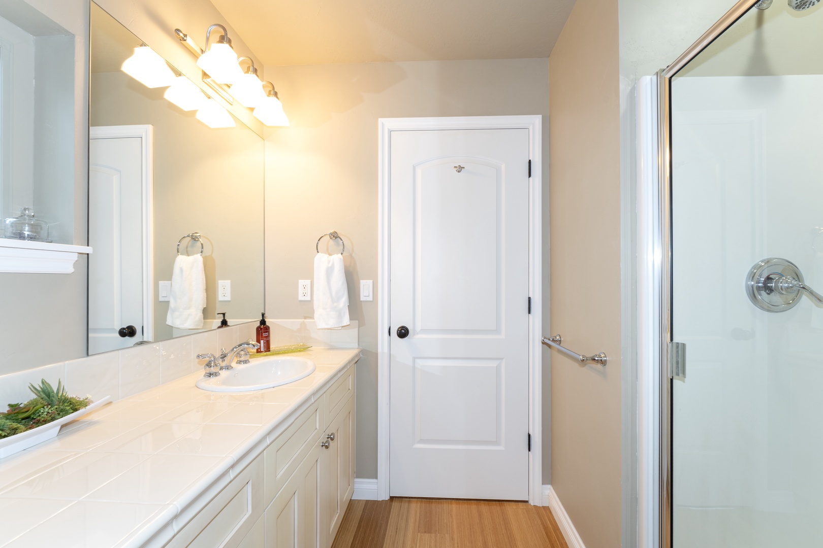 Step into your bright, spotless bathroom with fresh towels and a generous vanity. The walk-in shower awaits after a day of exploring—everything you need to refresh and unwind.