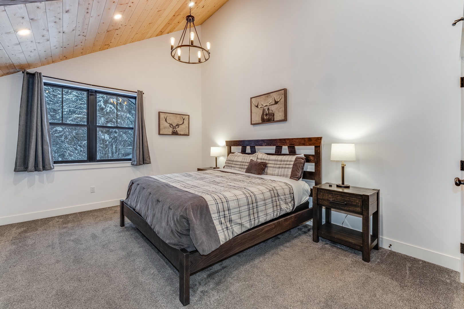 Rest peacefully in your rustic retreat with wood-paneled ceilings, cozy plaid bedding, and forest views from your private window.