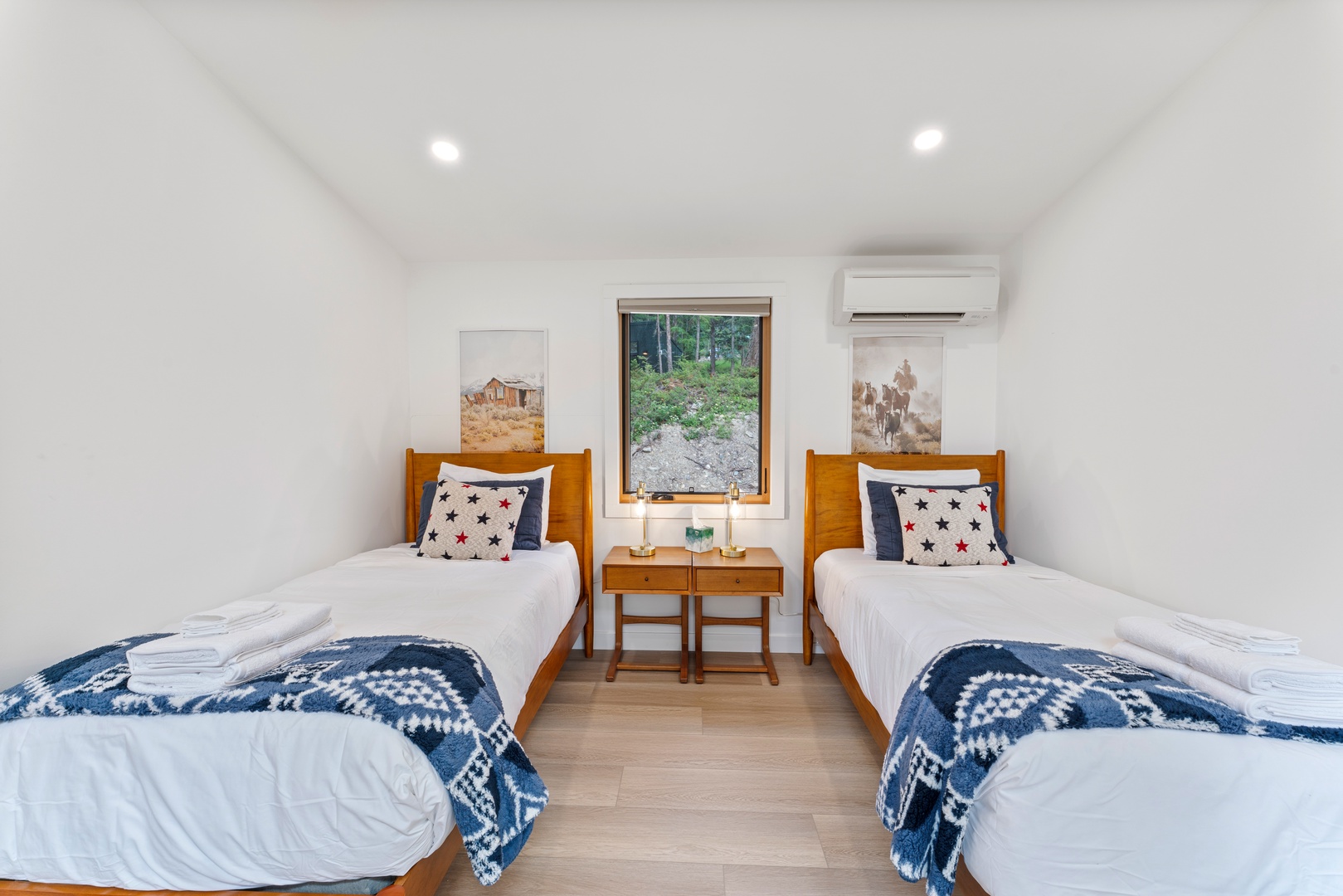 Two cozy twin beds await you in this bright, air-conditioned room with charming rustic artwork and a peaceful garden view that brings the outdoors in.