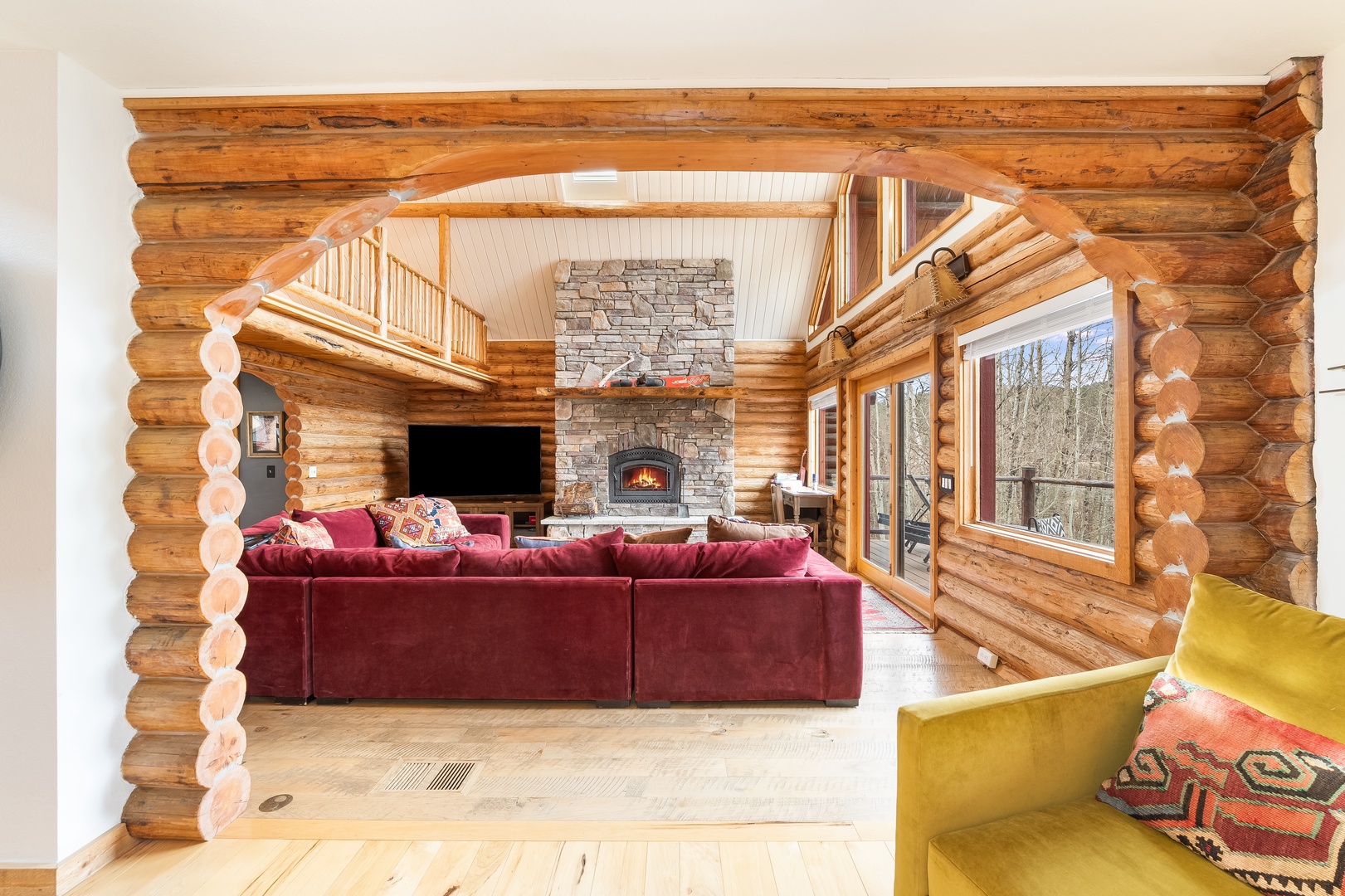 Cozy up by your crackling fireplace in this stunning log cabin living room, where natural wood and plush seating create the perfect mountain retreat.