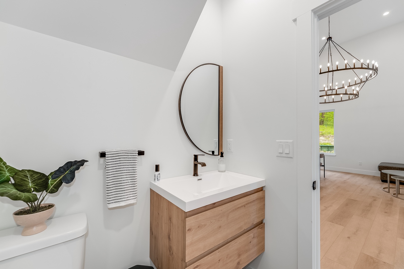 Freshen up in your stylish powder room with modern wood finishes, clean lines, and a soothing white palette that creates a spa-like retreat.