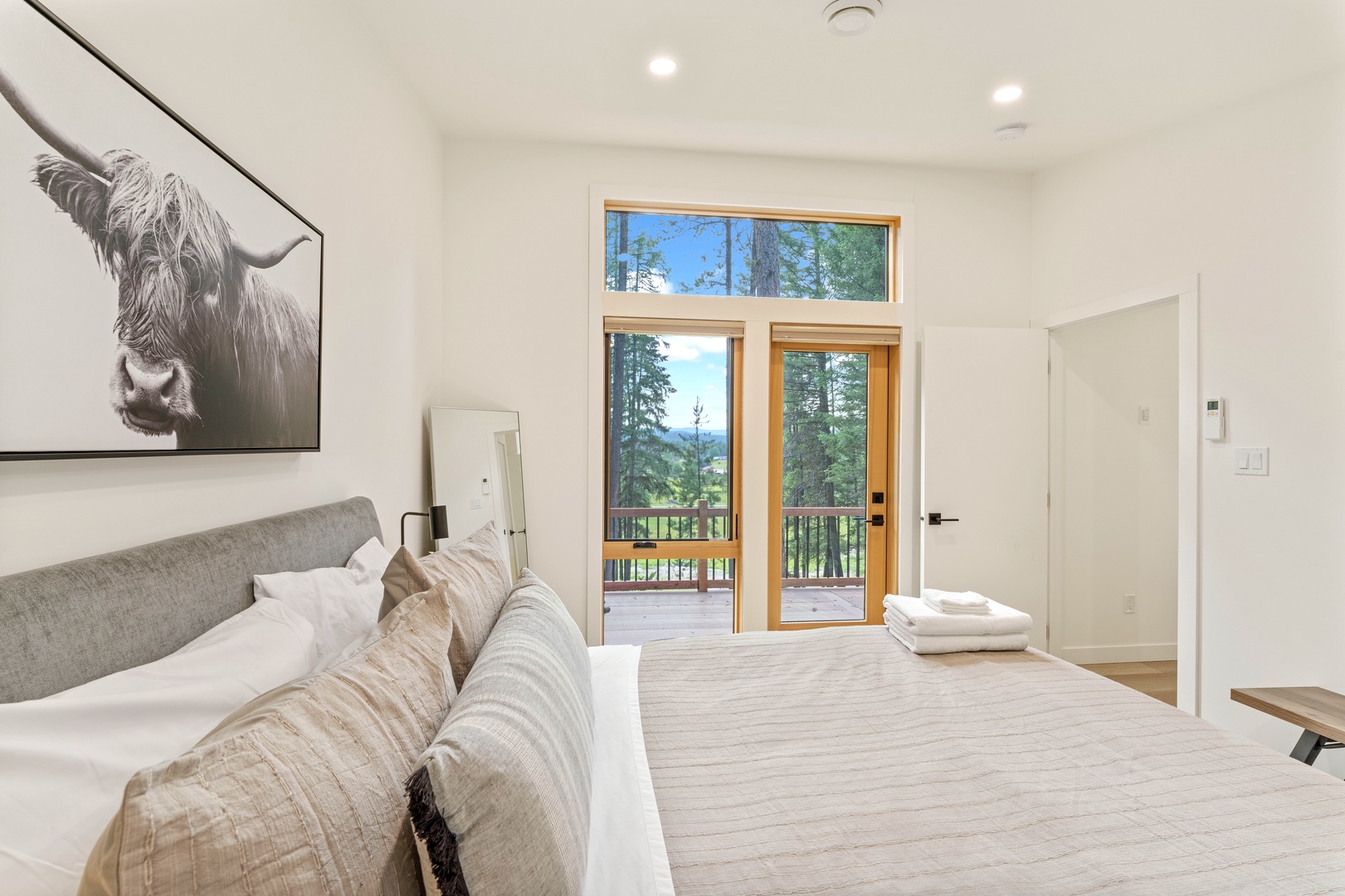 Wake up to mountain vistas through your private balcony doors, where plush linens and peaceful artwork create your serene retreat.