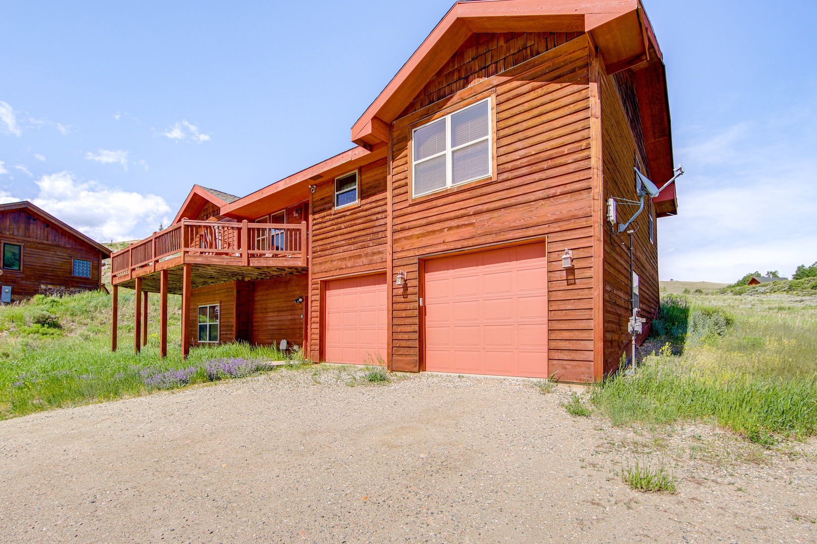 Charming cedar-sided mountain retreat featuring multi-level design with private garage and scenic meadow surroundings.