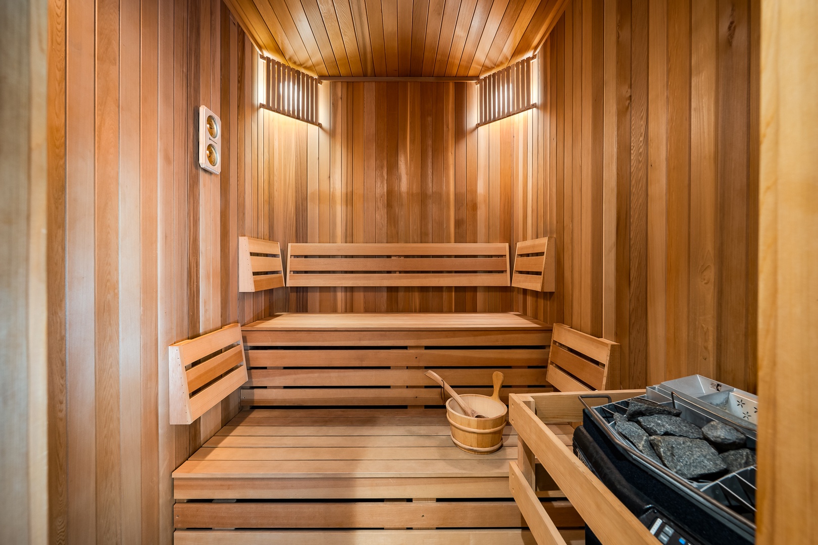 Step into your private wooden sauna where warm cedar surrounds you, complete with heated stones for the perfect steam experience.