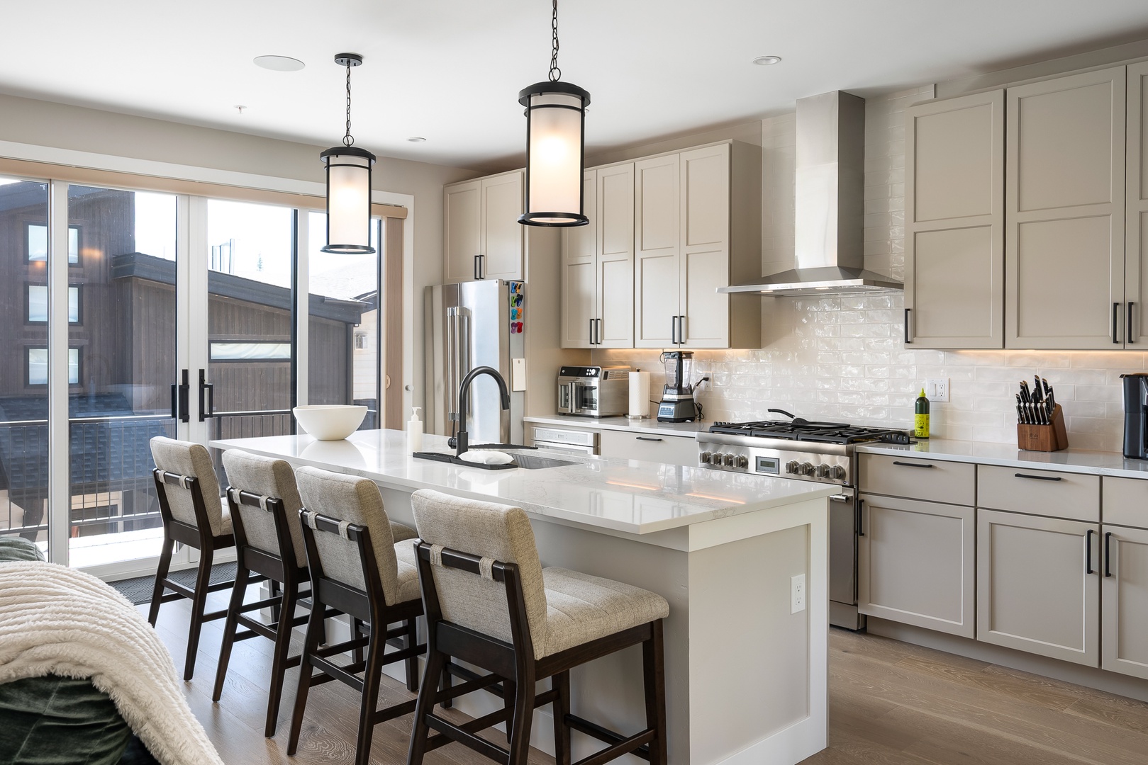 Your modern chef's kitchen awaits, featuring premium stainless appliances, and a spacious island perfect for morning coffee or preparing memorable meals together.