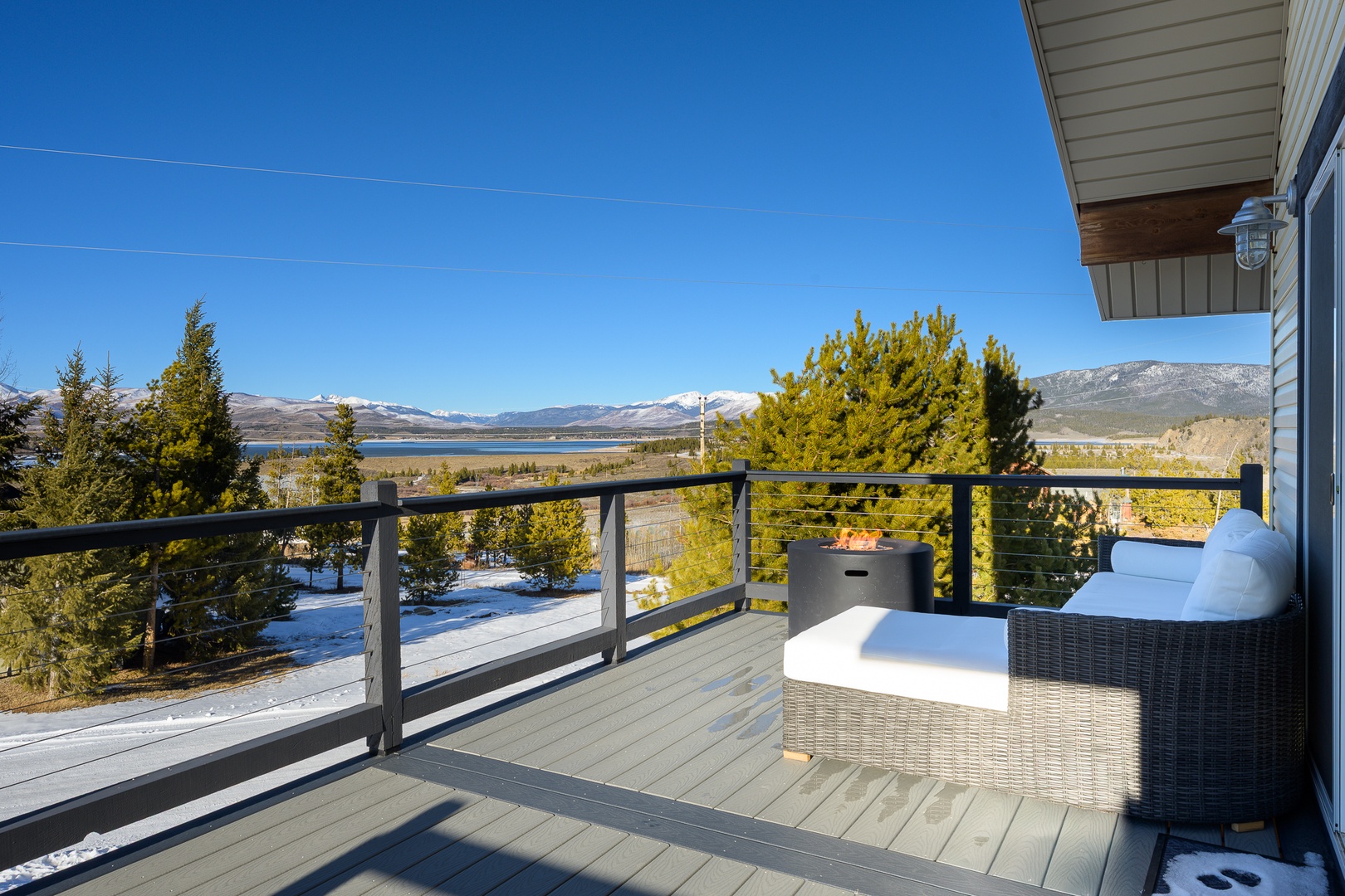 Relax on your private deck with stunning mountain views. The cozy seating invites you to unwind while soaking in breathtaking alpine scenery.