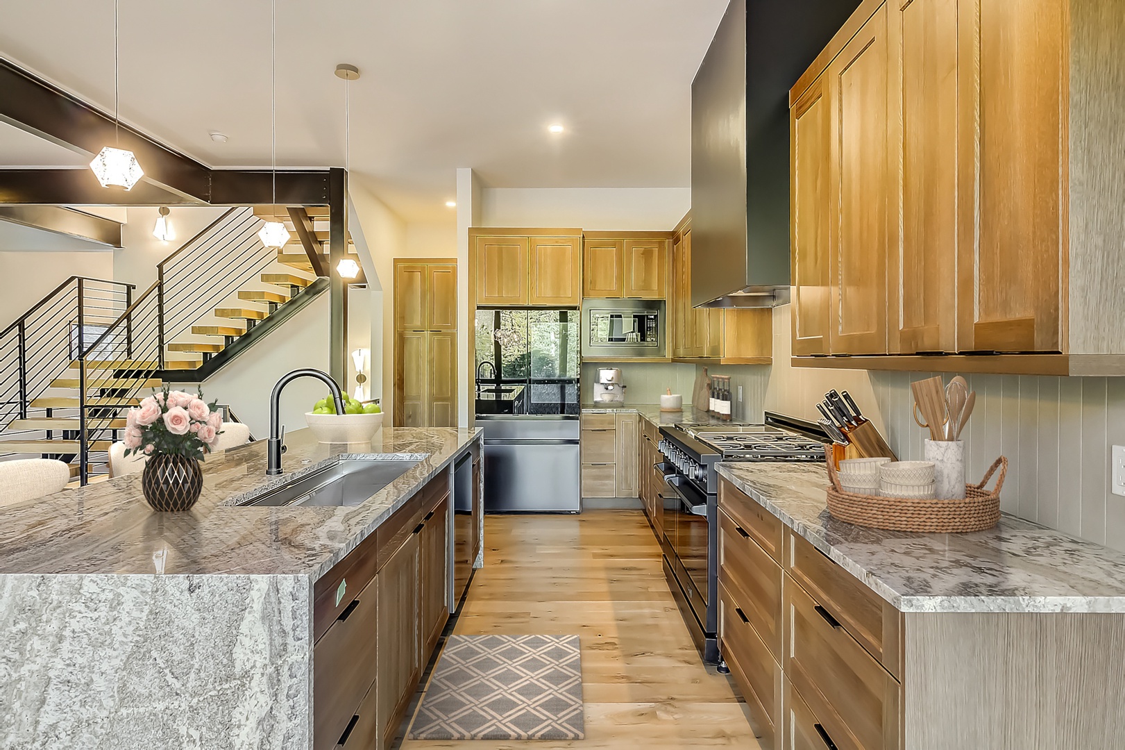 Your gourmet kitchen features marble counters, premium appliances, and warm wood cabinetry—perfect for cooking memorable meals together.