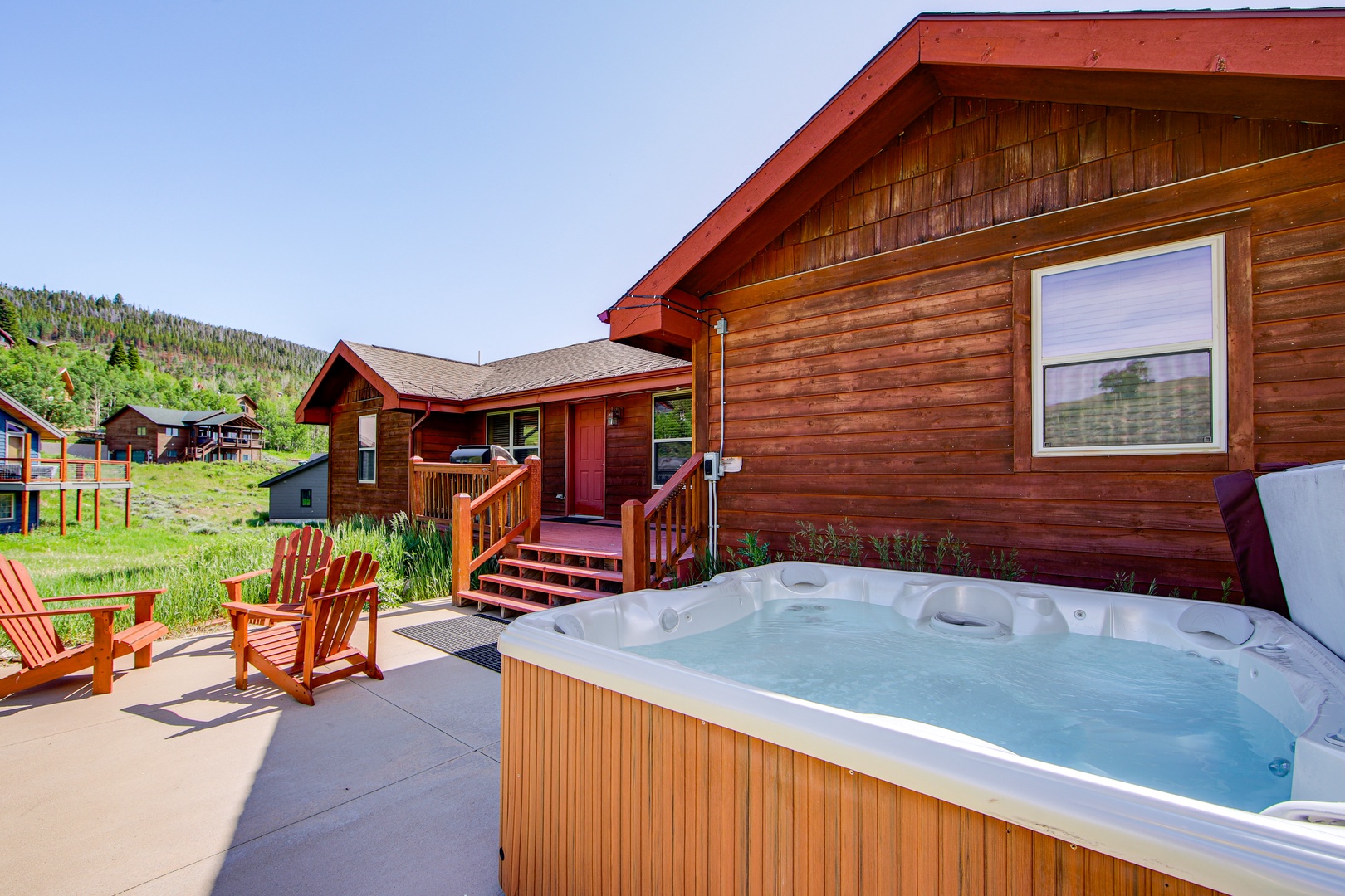 Soak in your private hot tub while gazing at forested mountains, then relax in Adirondack chairs on your spacious patio.