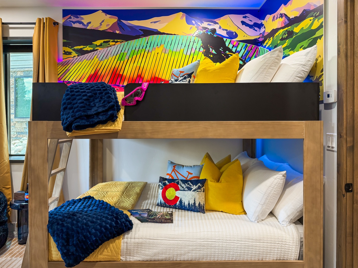 Dream big in your own cozy bunk beneath vibrant mountain artwork that brings Colorado's wild beauty right to your bedside. Perfect for families or friends who love adventure.