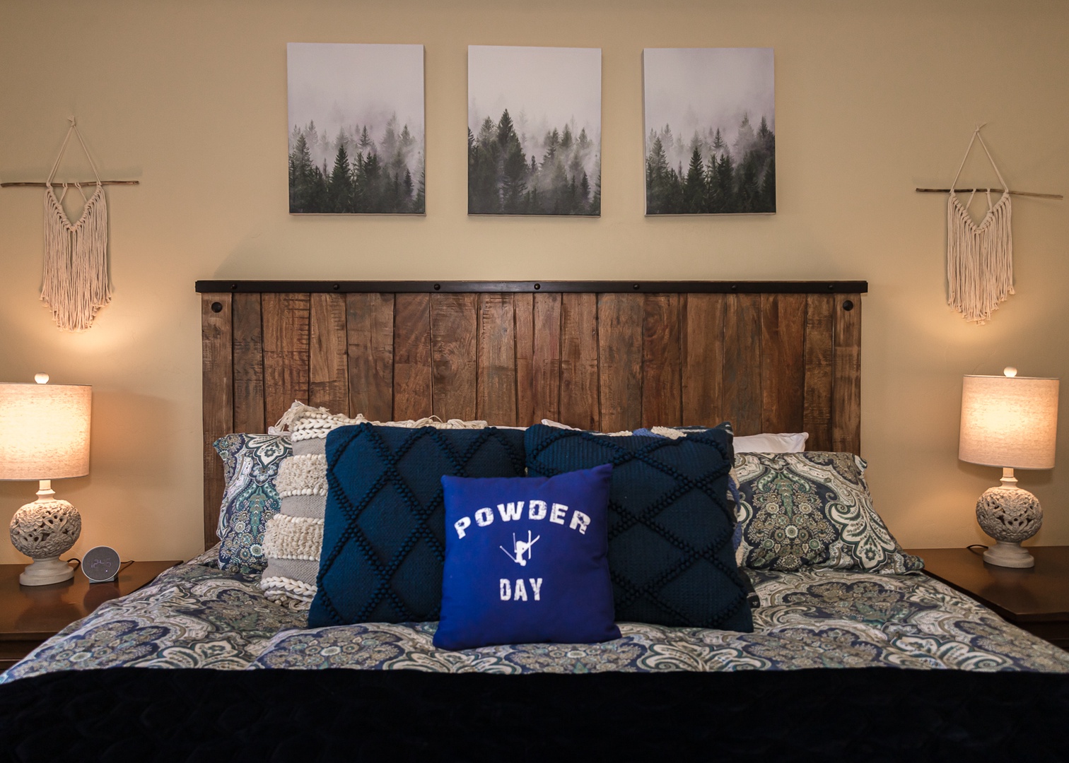 Sink into your cozy mountain-themed bedroom where rustic wood meets soft bedding and forest artwork sets the perfect retreat mood.