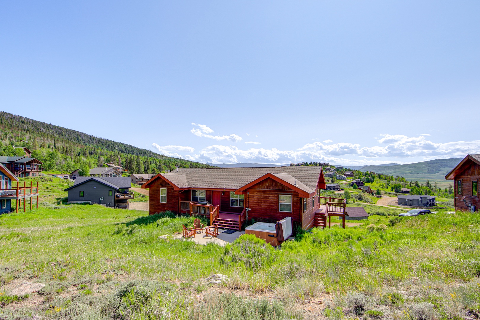 A charming mountain retreat nestled among rolling hills and forest, offering peaceful surroundings and stunning natural vistas.