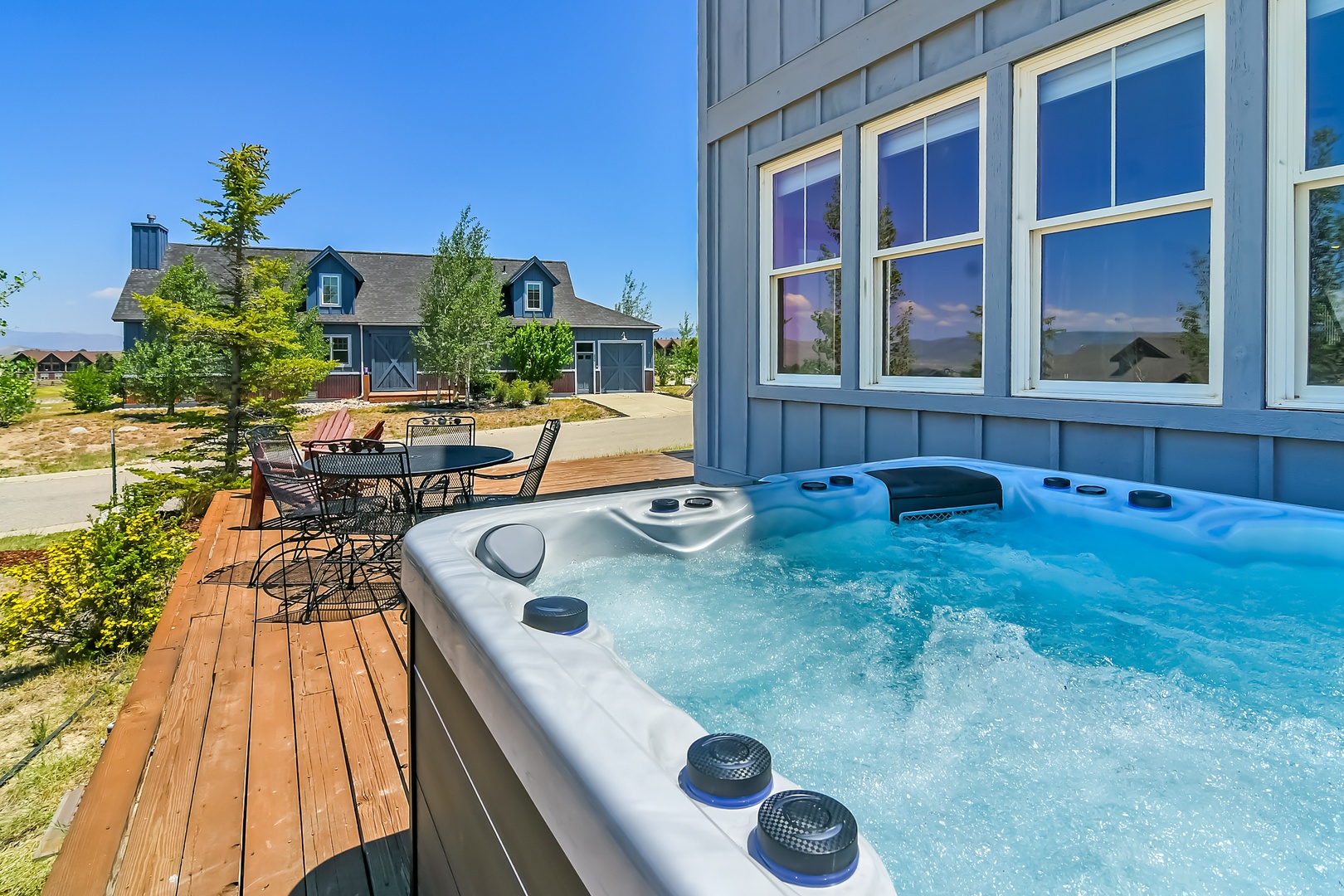 Your private hot tub on the sunny deck invites you to unwind while gazing at mountain reflections in the windows and soaking in the peaceful neighborhood views.