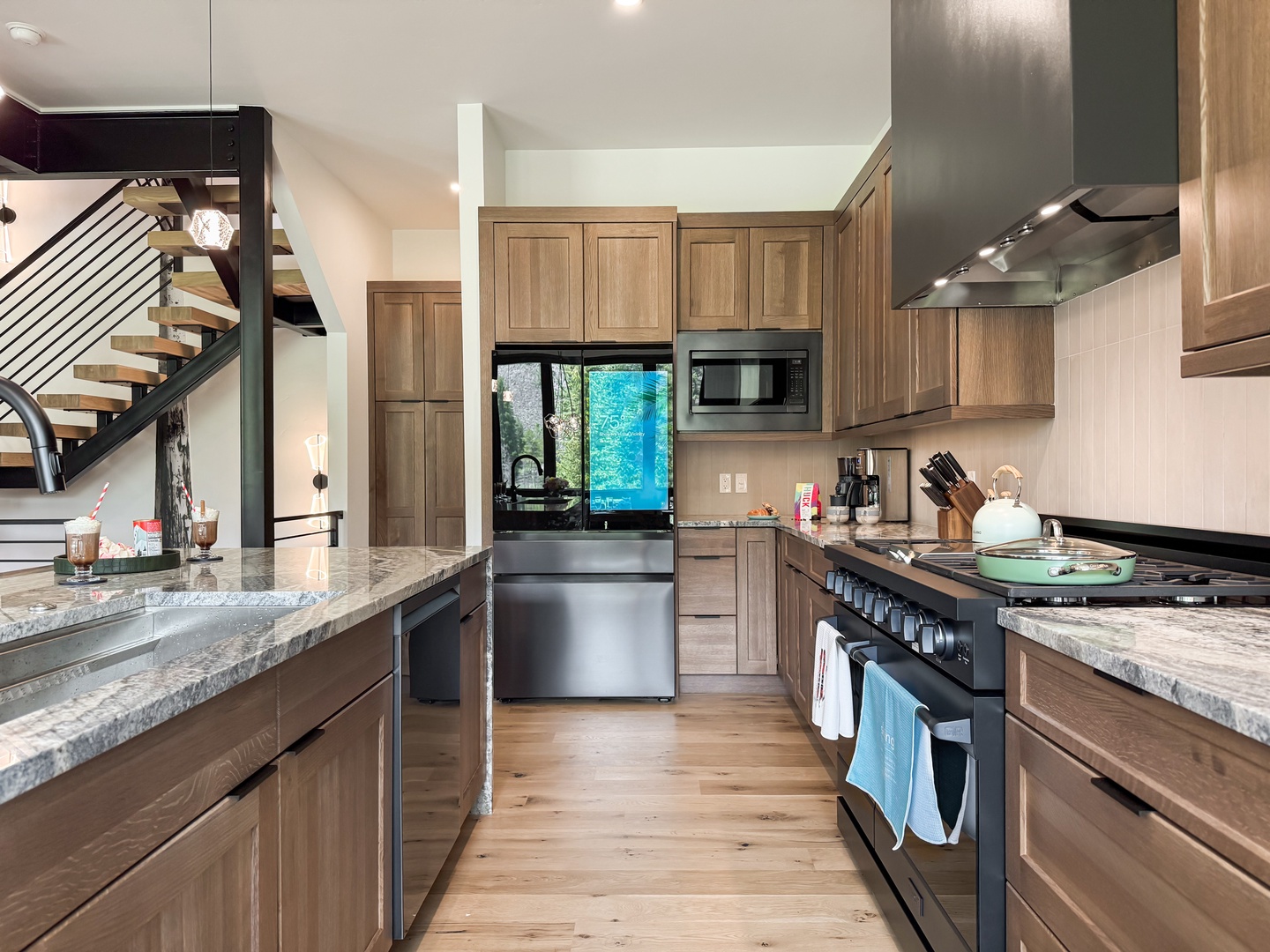 Your spacious chef's kitchen awaits, with gleaming granite counters, stainless steel appliances, and everything you'll need to whip up memorable meals during your stay.