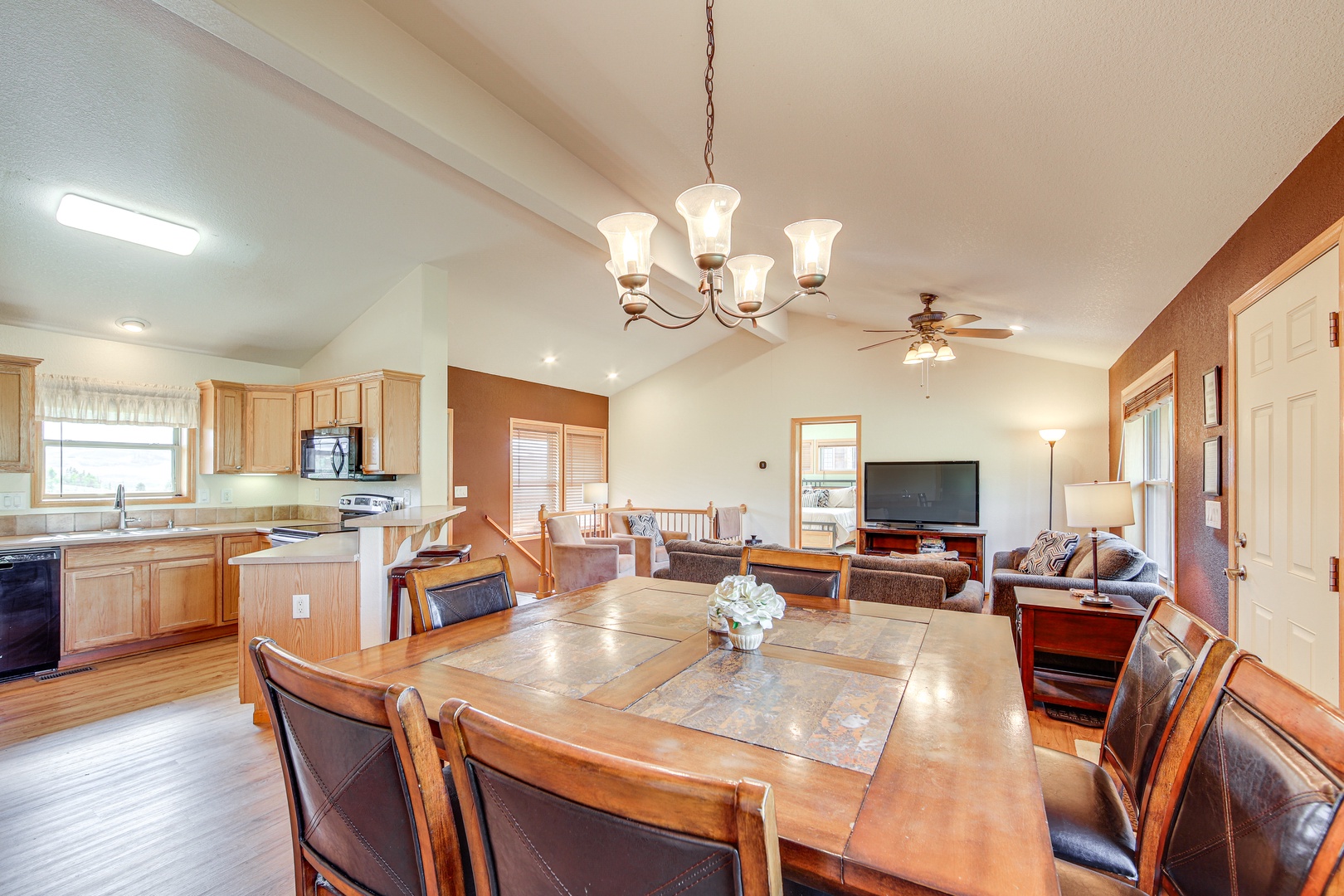 Gather around your spacious dining table while the open kitchen invites culinary adventures and the living room beckons for cozy evenings together.