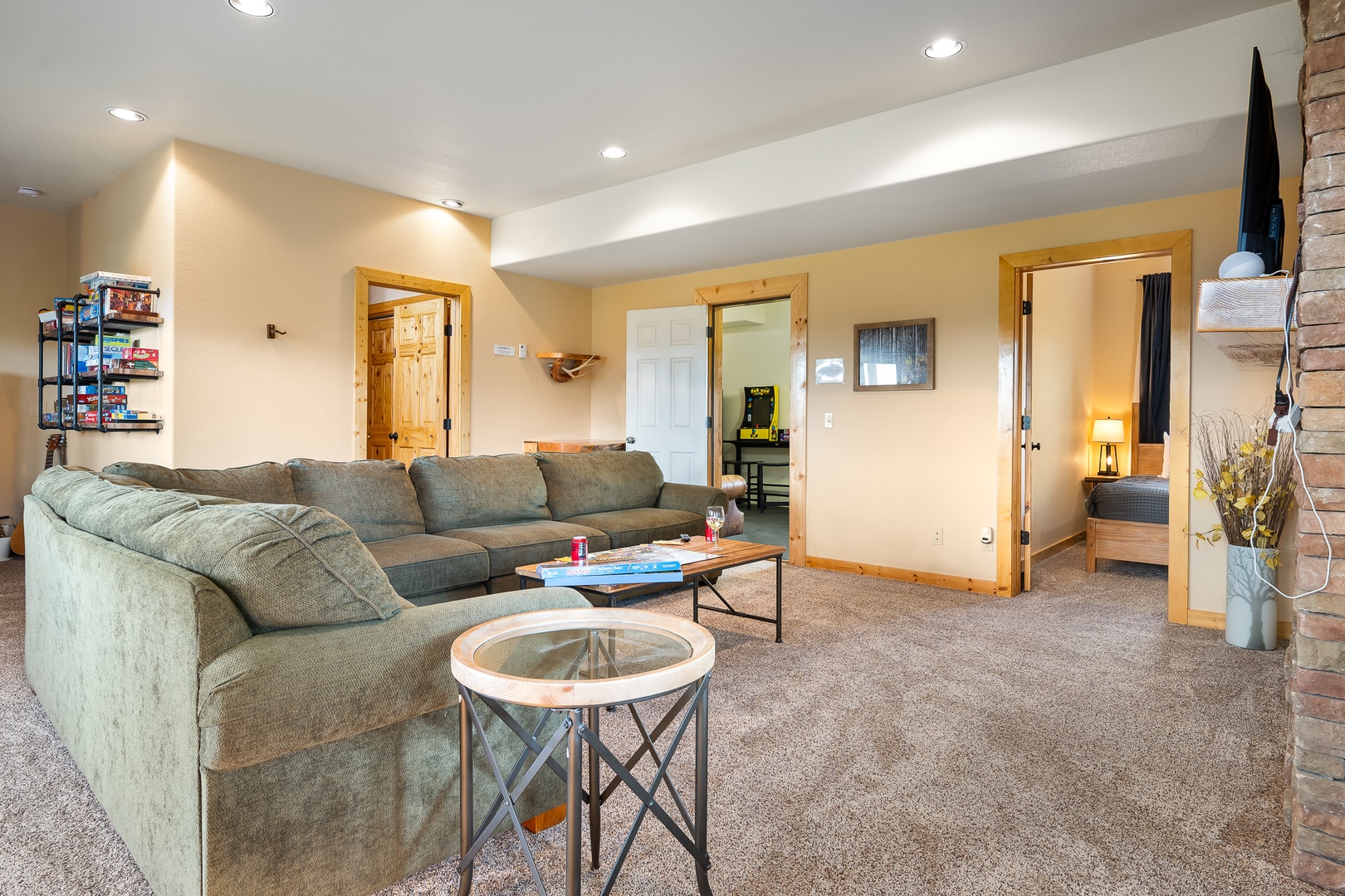Sink into the plush sectional sofa and unwind in this spacious, thoughtfully designed living room. With multiple doorways leading to private bedrooms and cozy carpeting underfoot, your group will find plenty of room to relax and reconnect.
